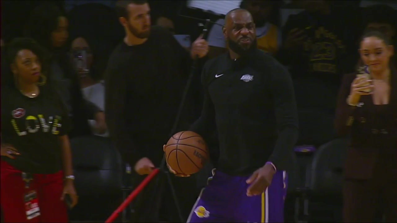 The Lakers with their pre-game ritual and LeBron James swishes the hook shot from almost the 3-point line on his second attempt with a replay