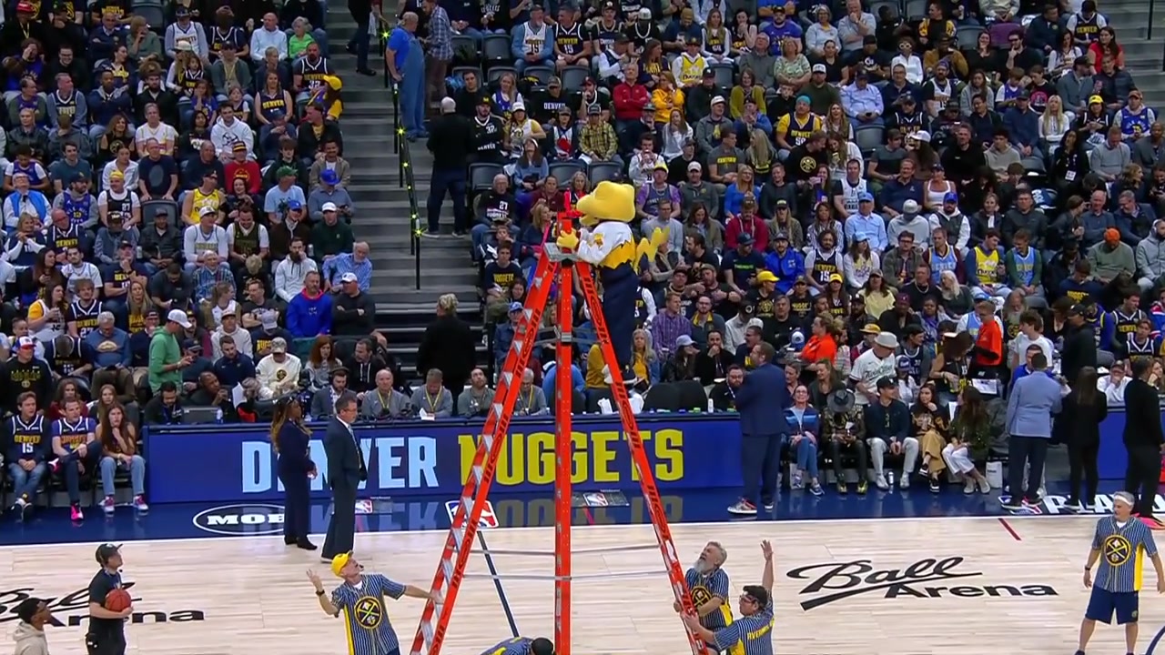Rocky the Nuggets' mascot hits the no look over the head halfcourt shot while 35 feet up high on a ladder with replays
