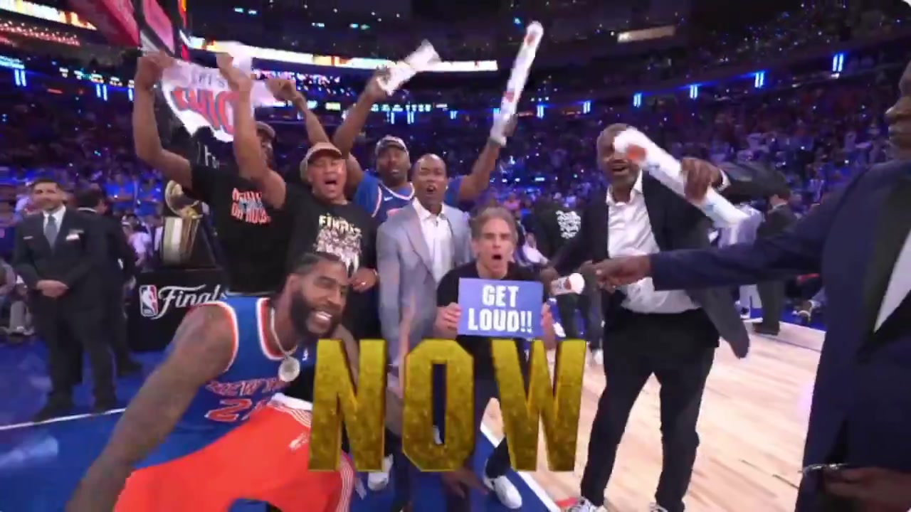 Ben Stiller and about 8 former Knicks players gather on the court during a timeout to try and hype the crowd up in the 4th quarter