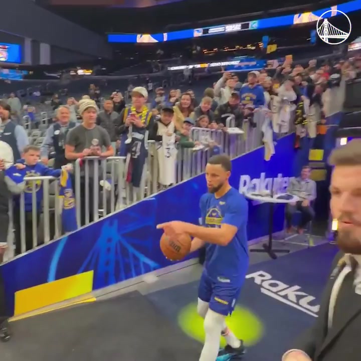 Steph Curry makes a shot from the opposite end of the court near the tunnel in pregame warm ups