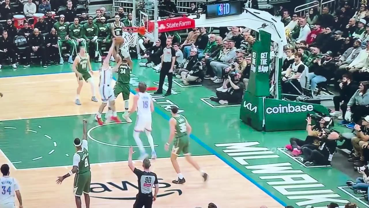Mr Giannis Antetokounmpo performs a defensive action on Mr Brooks Barnhizer