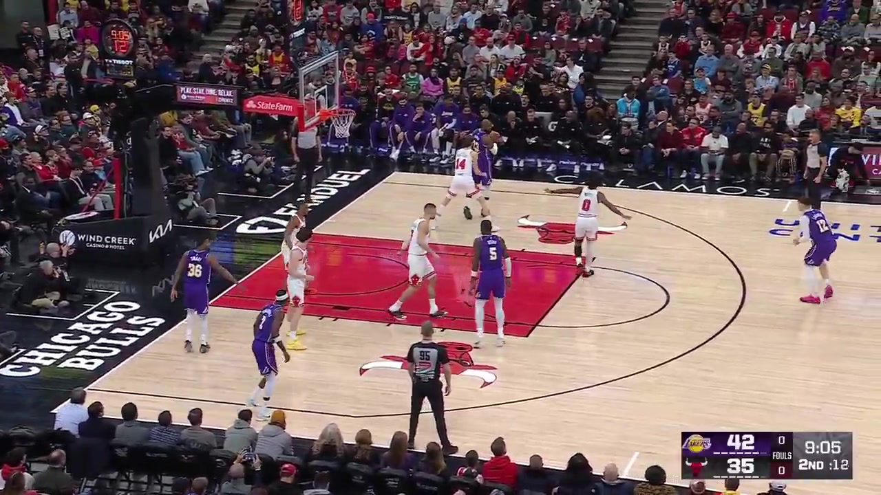 LeBron James powers through for an and-one layup over Matas Buzelis