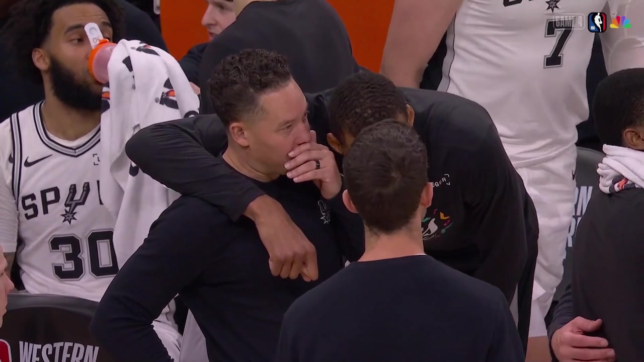 Tim Duncan talks to Gregg Popovich and Victor Wembanyama talks with coach Mitch Johnson