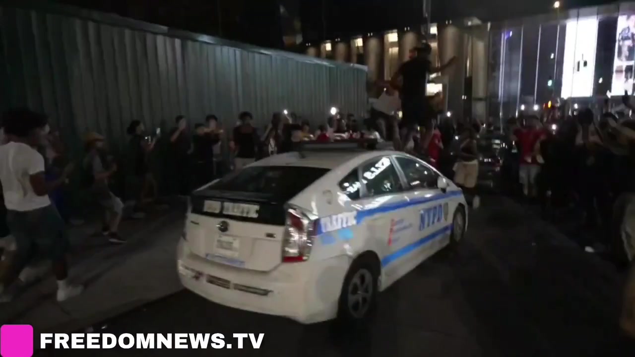 NYPD car windshield SMASHED UP as crowds Jump on top near Madison Square Garden during Knicks Game