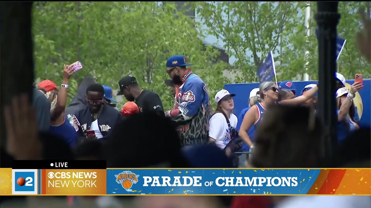 Karl-Anthony Towns signs on hats shirts and a basketball for the fans