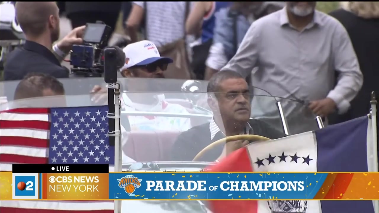 Karl-Anthony Towns with a cigar and a trophy on the first bus