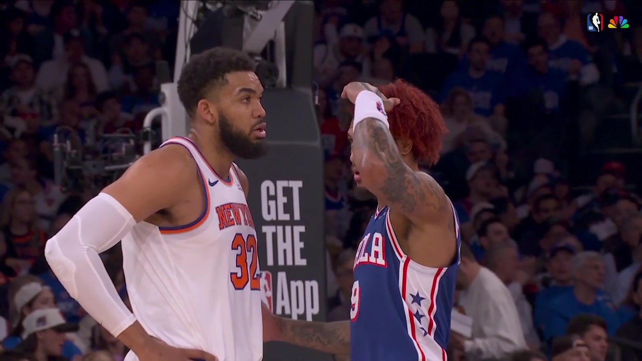 Kelly Oubre Jr measures his height against Karl-Anthony Towns making him smile