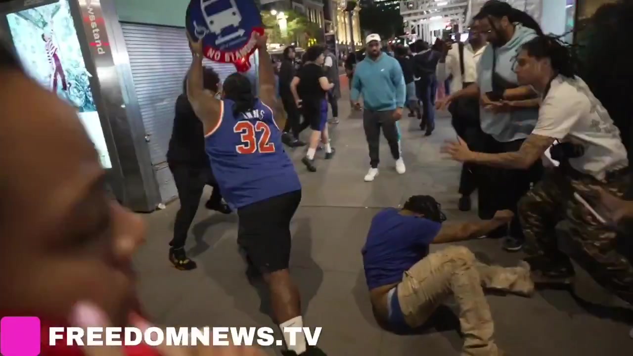 Huge fight between Knicks Fans on 42nd street man bashed multiple times with a bus stop sign Cops make multiple arrests