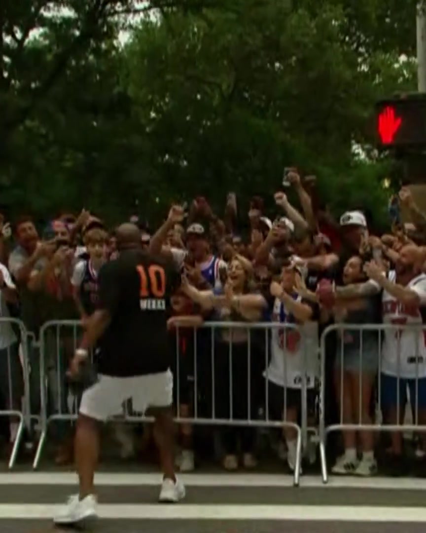 Mike Brown daps the fans before the parade starts