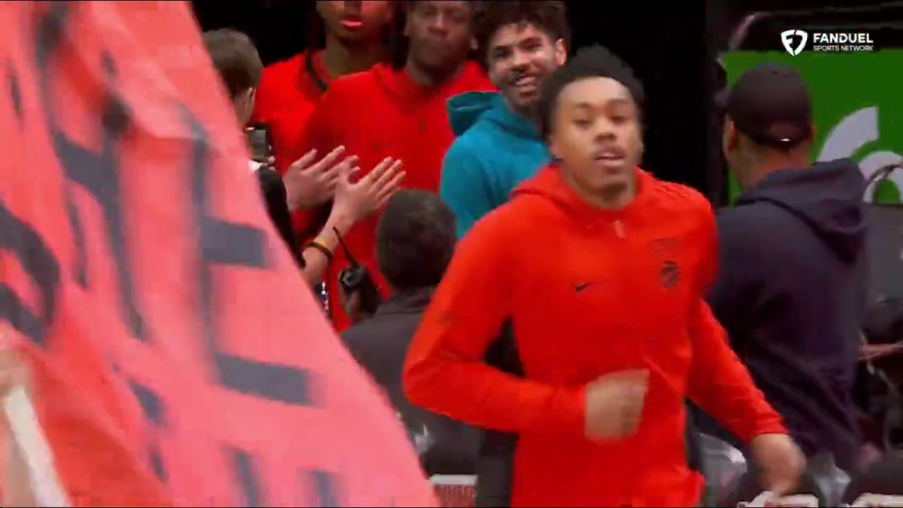 Lamelo Ball runs out the tunnel with the Raptors players