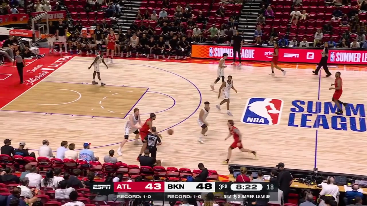 Gabe Madsen makes the tough reverse layup on Danny Wolf