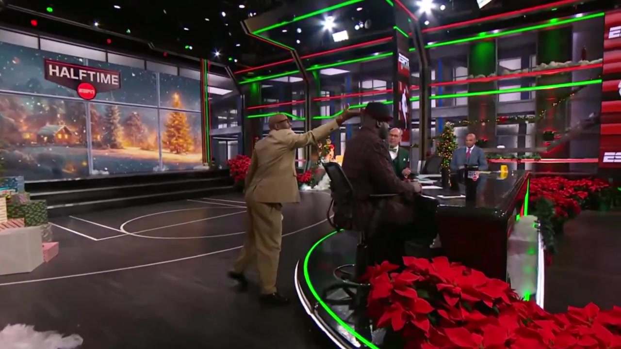 Shaq bull rushes through the ESPN background screen