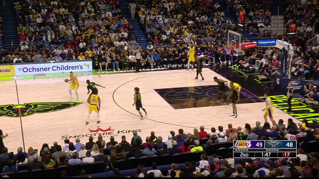 LeBron James soars way up in the air for the alley-oop dunk off a lob by Luka with replays