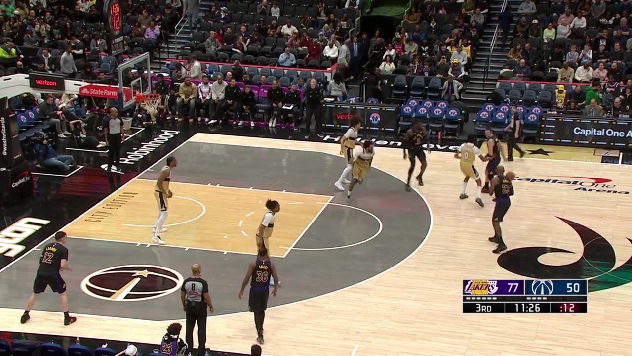 LeBron James delivers a one-handed lob over the defense to Deandre Ayton for the jam
