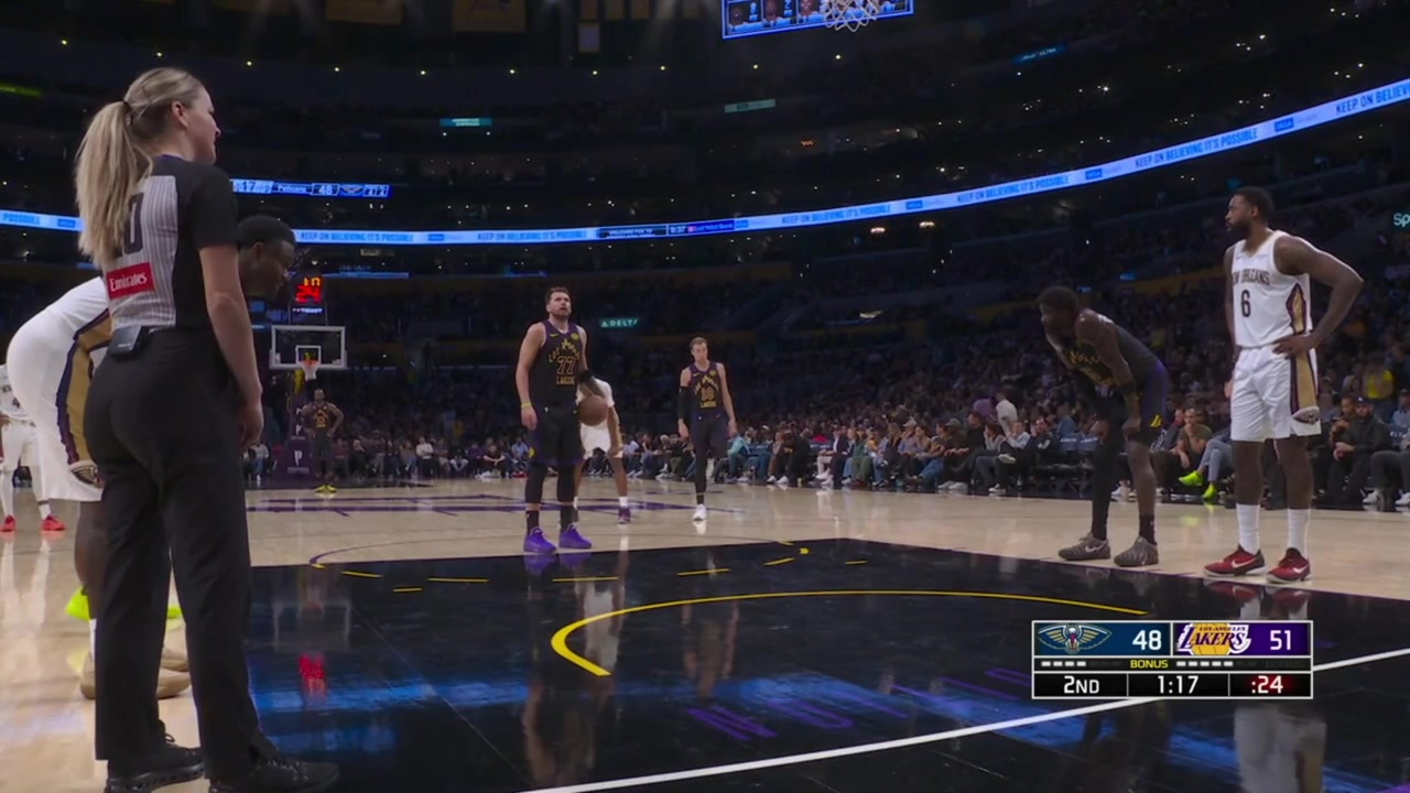 Luka Doncic misses the 1st free throw complains to the referees about a lane violation by a Pelican player makes the second free throw keeps on complaining receives a technical foul and Austin Reaves hold him back with a replay