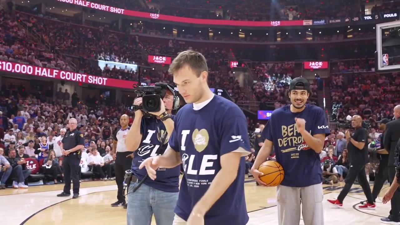 A Cavaliers fan named Cooper hits the halfcourt shot to win 10000With a replay