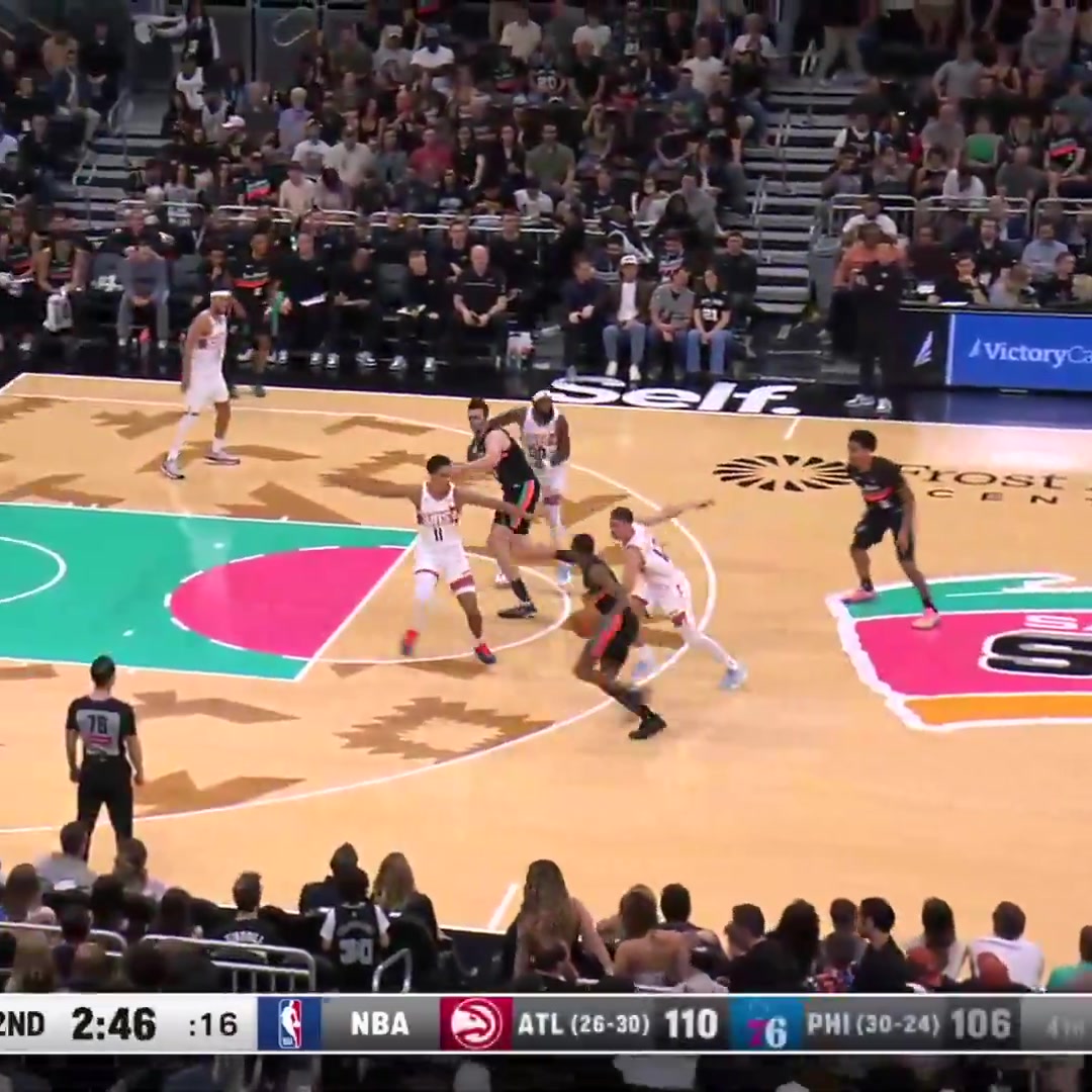 Luke Kornet finishes the oop with a reverse jam points to the bench then flashes the hook-em to the Austin crowd