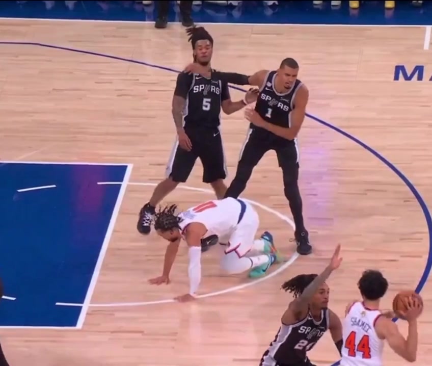 Wemby shoves Jalen Brunson who reacts while Wemby laughs