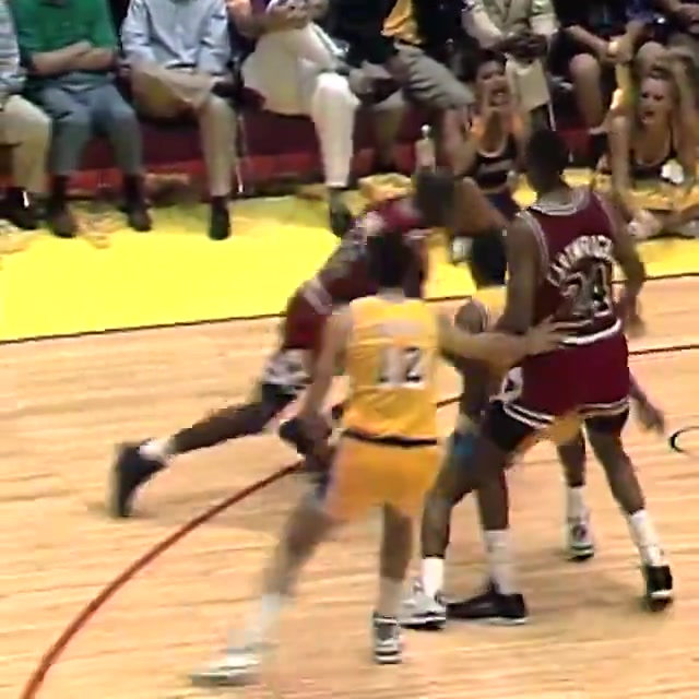 Michael Jordan rises up and jams on Sam Perkins in Game 2 of the 1991 NBA Finals