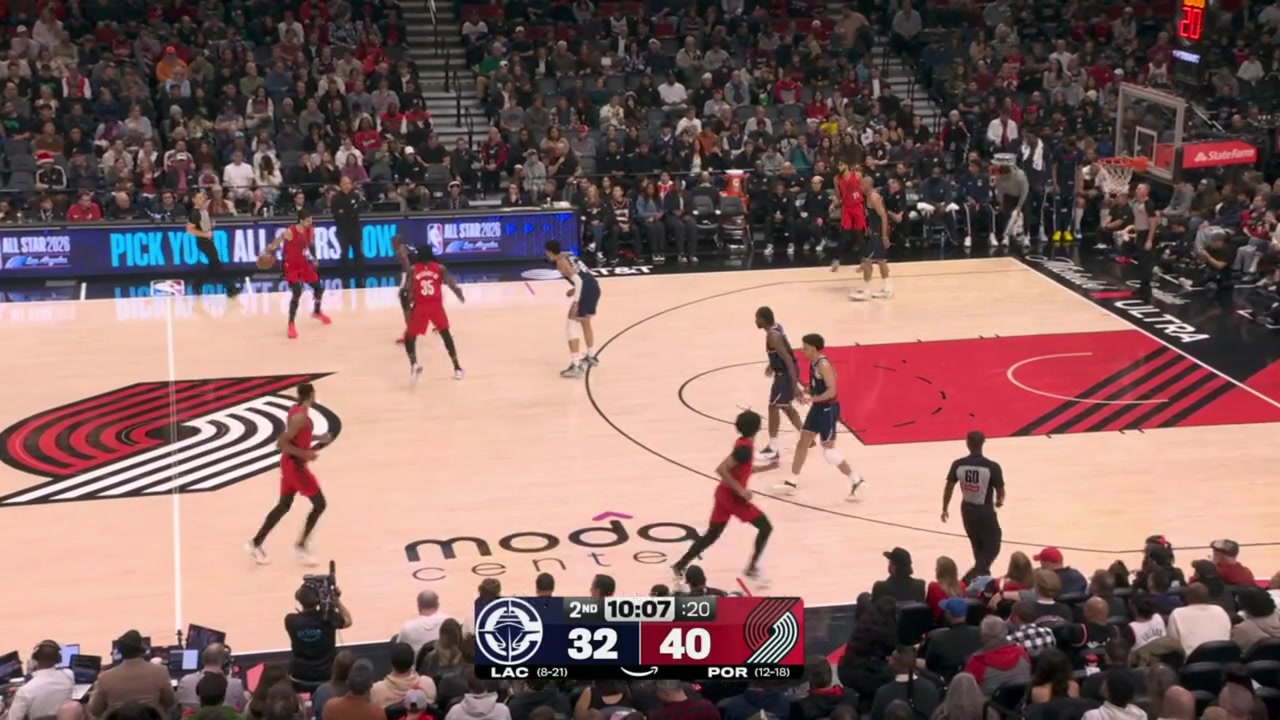 Robert Williams III finishes the alley-oop dunk off a lob by Deni Avdija despite the contact by Kobe Sanders