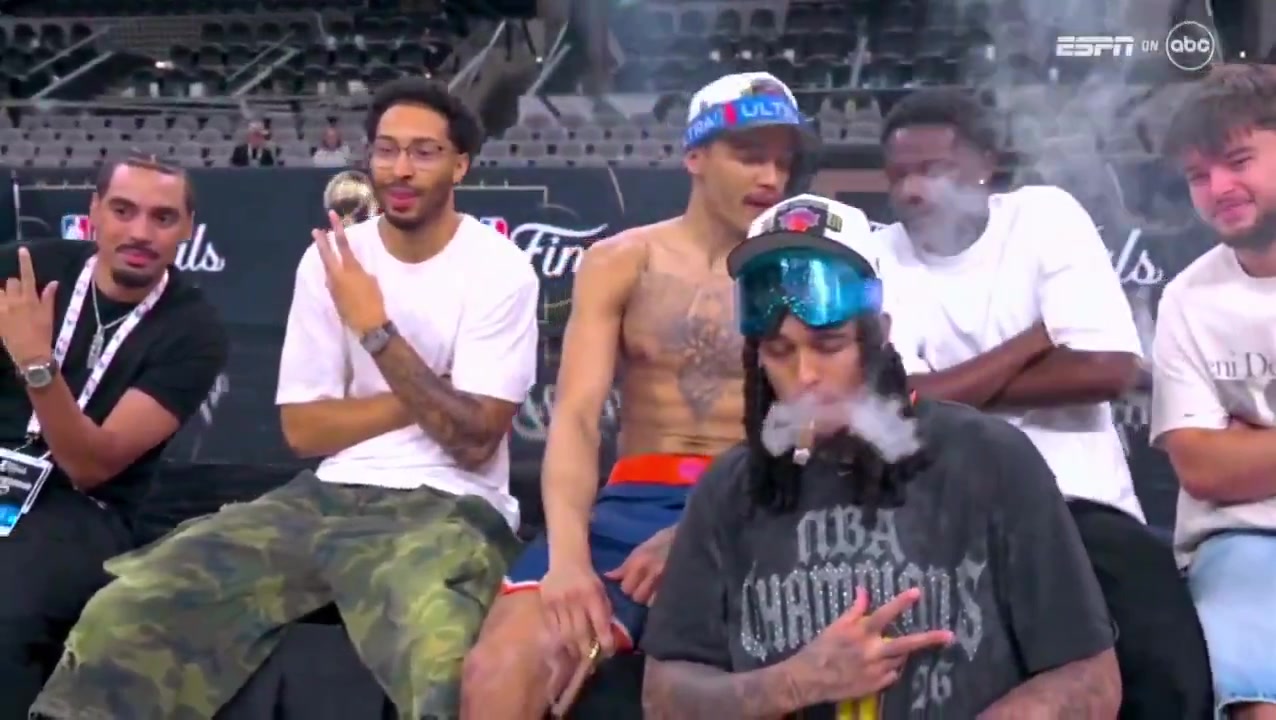 Knicks players smoking cigars on the Spurs court after winning an NBA championship