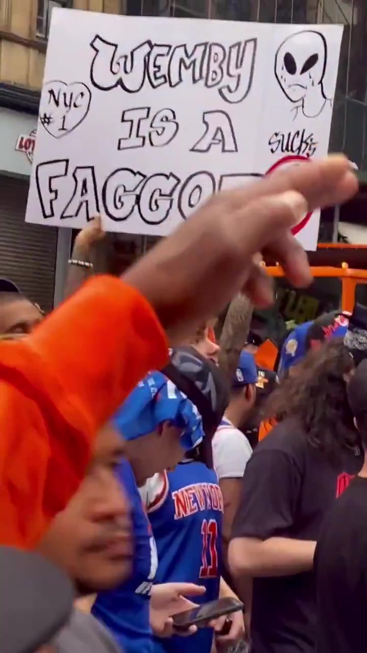A Knicks fan with a Wembanyama sign in the parade