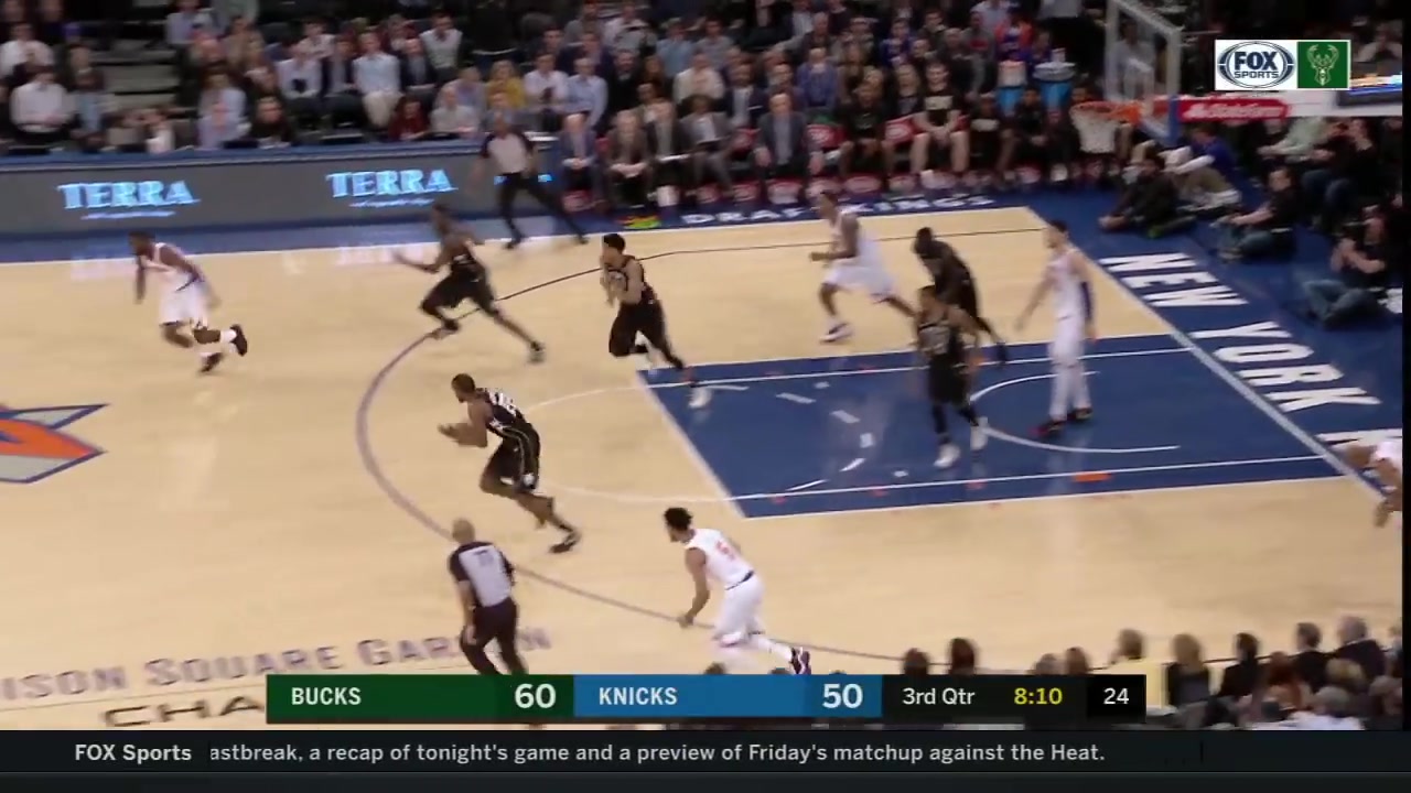 Giannis Antetokounmpo jumps over Tim Hardaway Jr
