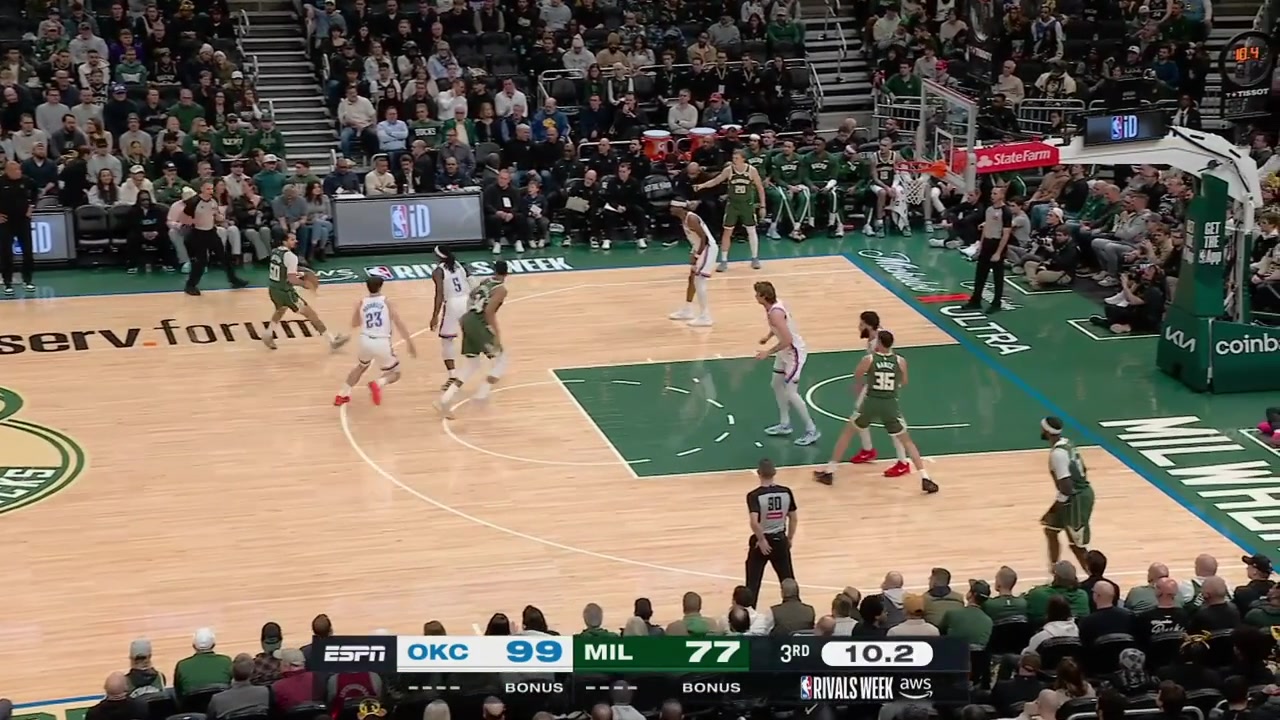 Giannis Antetokounmpo gets tangled up with Brooks Barnhizer under the rim and both players fall on the floor