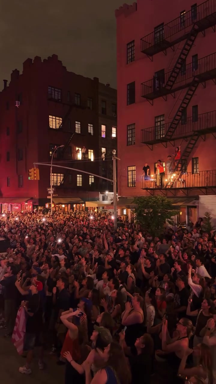 Knicks fans block party watching the game projected onto the side of a building react to OG's tip in