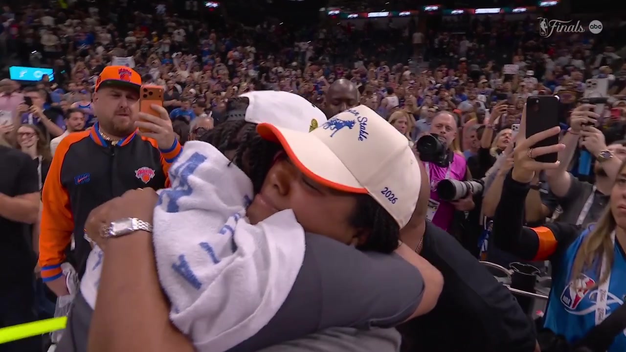 Jalen Brunson hugs with his family after winning a championship