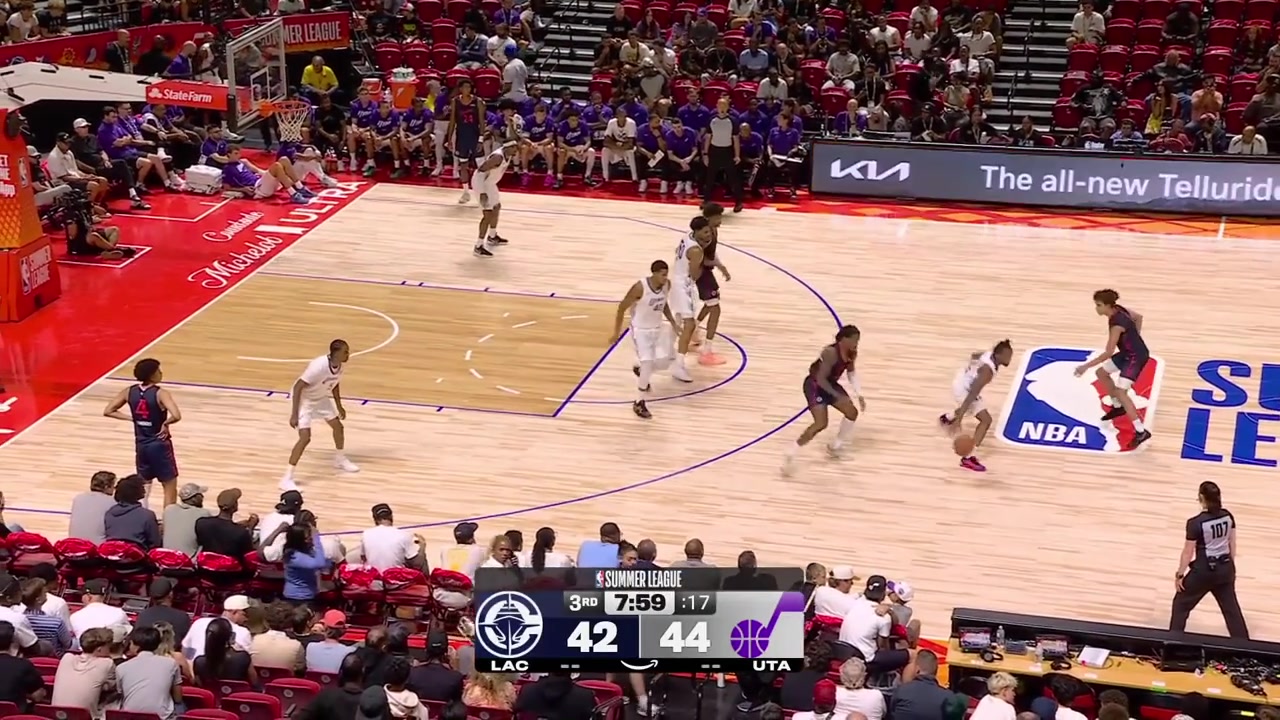 Baba Miller goes by the defender for the And-1 two-handed jam despite being hit in the head with replays
