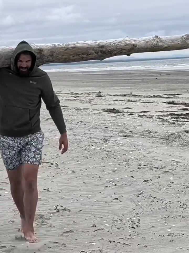 Steven Adams casually single-handedly carrying a massive log across the beach to help throw together a bonfire